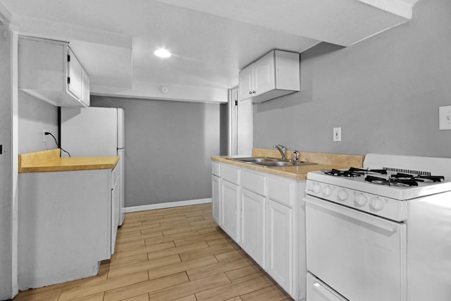18241 Roy St, Lansing, IL 60438 - kitchen with white appliances, a sink, light countertops, light wood-style floors, and white cabinets