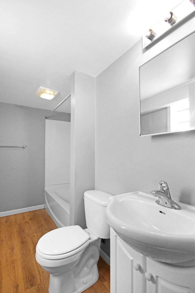 18241 Roy St, Lansing, IL 60438 - full bathroom with vanity, toilet, wood finished floors, bathtub / shower combination, and baseboards