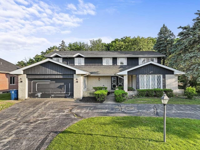 7415 W Ute Ln, Palos Heights, IL 60463 - view of front facade featuring asphalt driveway, brick siding, a garage, and a front lawn
