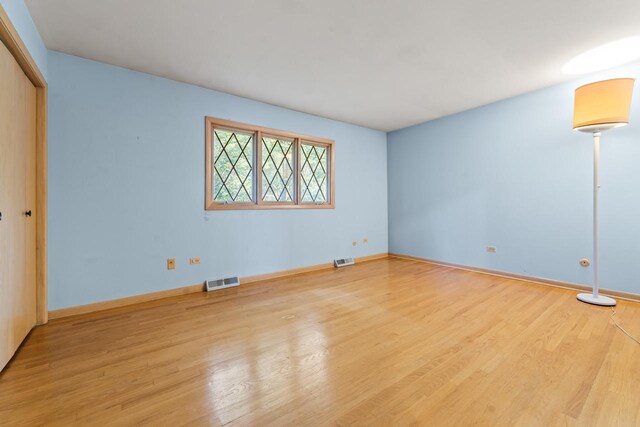 7415 W Ute Ln, Palos Heights, IL 60463 - unfurnished bedroom with wood finished floors and a closet