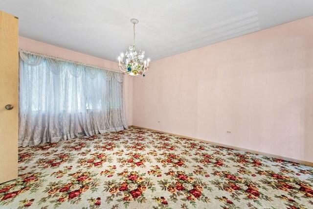 7415 W Ute Ln, Palos Heights, IL 60463 - carpeted empty room with a chandelier and baseboards