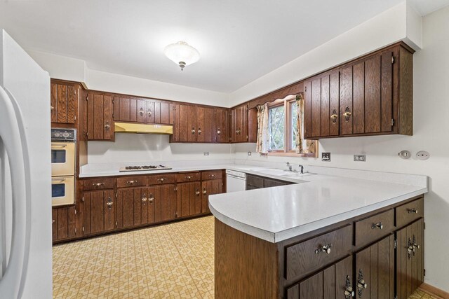 7415 W Ute Ln, Palos Heights, IL 60463 - kitchen with white appliances, under cabinet range hood, light countertops, light flooring, and a peninsula