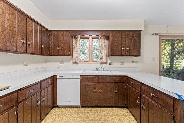 7415 W Ute Ln, Palos Heights, IL 60463 - kitchen featuring dishwasher, light countertops, light flooring, and dark brown cabinets