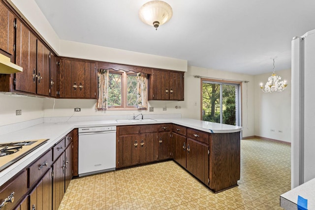 7415 W Ute Ln, Palos Heights, IL 60463 - kitchen with white appliances, a peninsula, light flooring, a chandelier, and light countertops