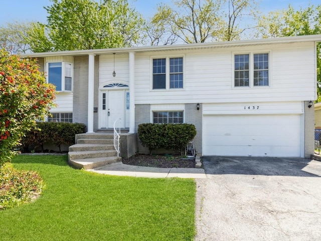 1437 S Busse Rd, Mount Prospect, IL 60056 - bi-level home with brick siding, an attached garage, driveway, and a front yard