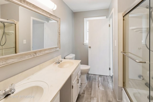 1437 S Busse Rd, Mount Prospect, IL 60056 - bathroom with toilet, double vanity, and wood finished floors