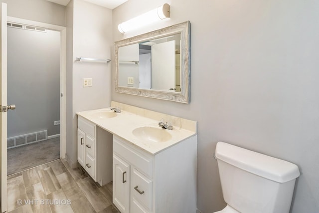 1437 S Busse Rd, Mount Prospect, IL 60056 - full bathroom with wood finished floors, toilet, and double vanity
