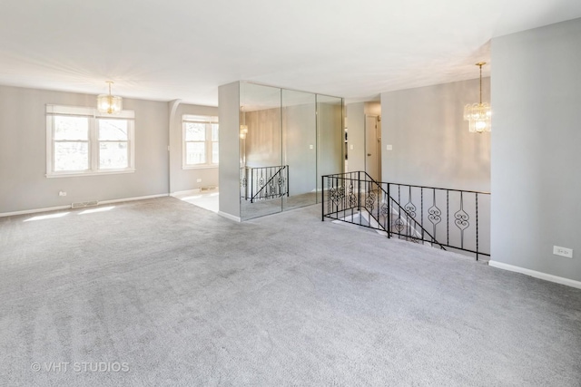 1437 S Busse Rd, Mount Prospect, IL 60056 - carpeted empty room with a chandelier and baseboards