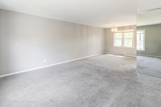 1437 S Busse Rd, Mount Prospect, IL 60056 - carpeted empty room with baseboards and a chandelier