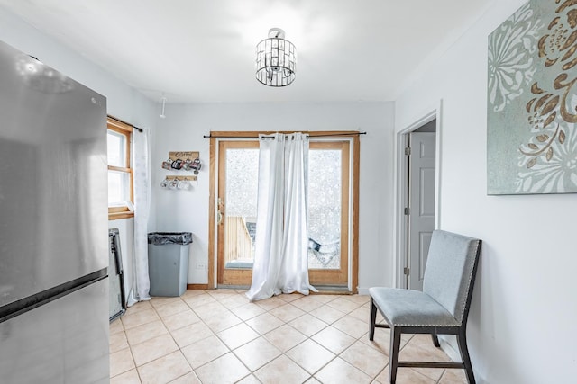 3801 W 65th Pl, Chicago, IL 60629 - sitting room with light tile patterned floors, a chandelier, and baseboards