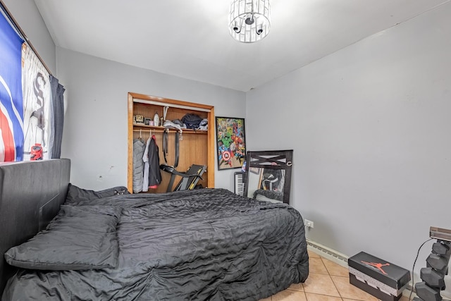 3801 W 65th Pl, Chicago, IL 60629 - bedroom with light tile patterned flooring, a closet, and a baseboard radiator