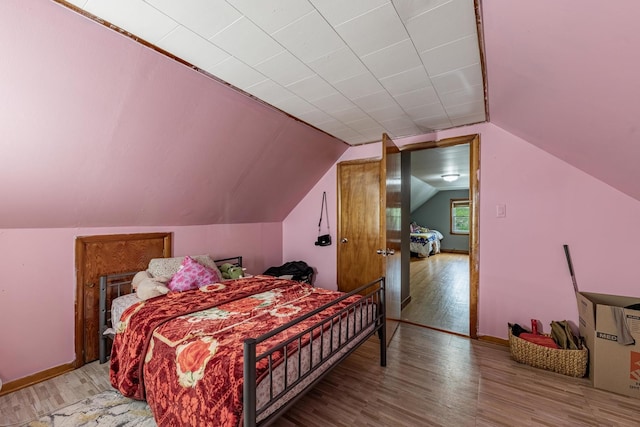 3801 W 65th Pl, Chicago, IL 60629 - bedroom featuring wood finished floors, vaulted ceiling, and baseboards