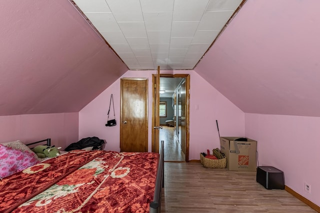 3801 W 65th Pl, Chicago, IL 60629 - bedroom featuring wood finished floors, vaulted ceiling, and baseboards