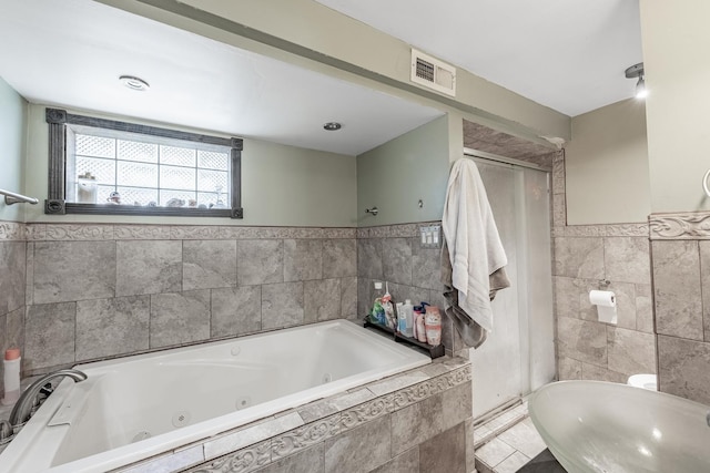 3801 W 65th Pl, Chicago, IL 60629 - full bath featuring tile walls, a tub with jets, and a wainscoted wall