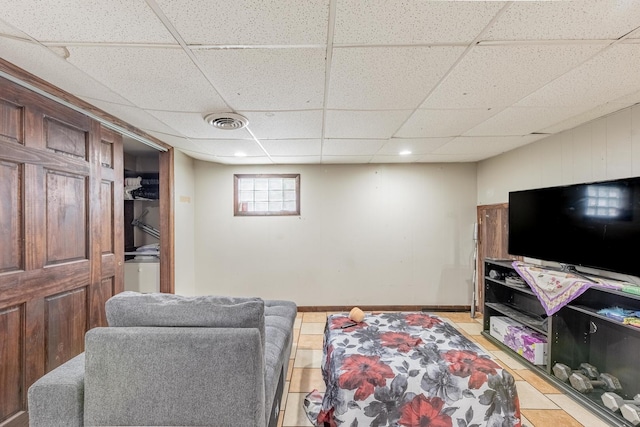 3801 W 65th Pl, Chicago, IL 60629 - living room featuring a paneled ceiling, light tile patterned flooring, and baseboards