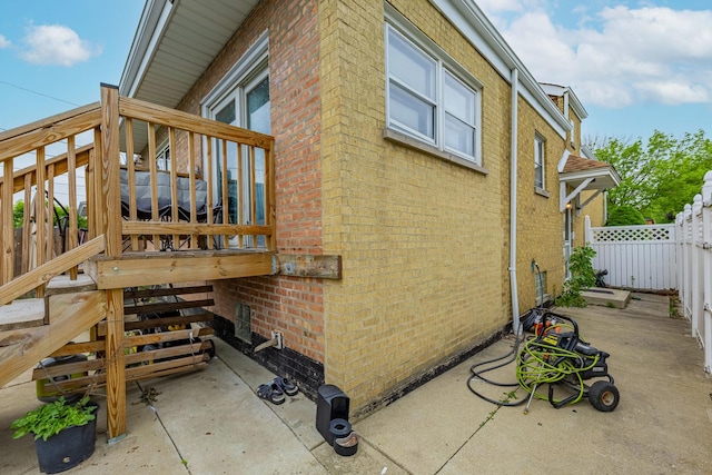 3801 W 65th Pl, Chicago, IL 60629 - view of side of property featuring brick siding, stairs, and a patio area