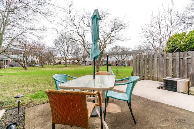 view of patio / terrace featuring central AC unit, a residential view, outdoor dining area, and fence