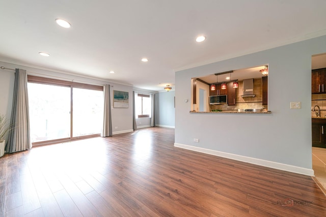 unfurnished living room featuring dark wood-type flooring, baseboards, and recessed lighting