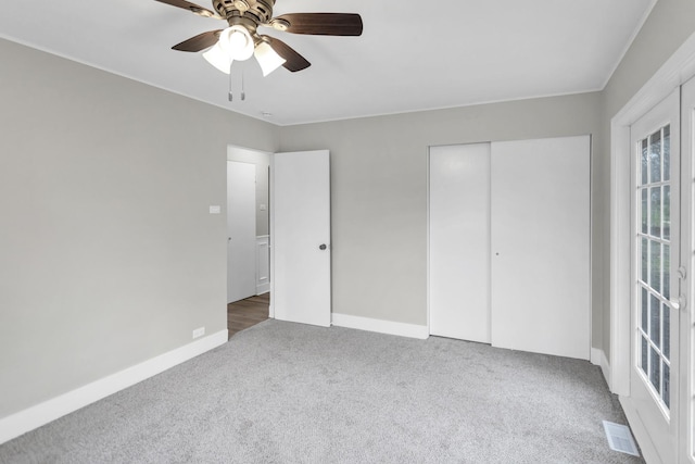 unfurnished bedroom featuring carpet flooring, visible vents, a closet, and baseboards