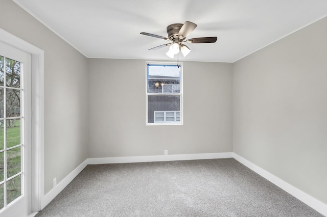 carpeted empty room with baseboards and ceiling fan