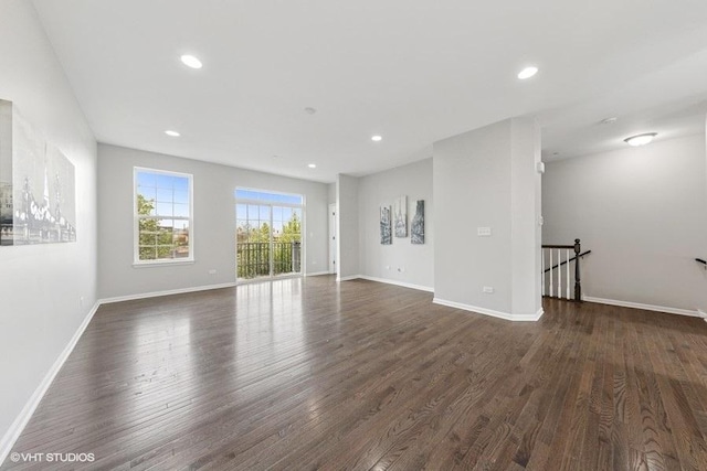 unfurnished living room with baseboards, recessed lighting, and dark wood-style flooring