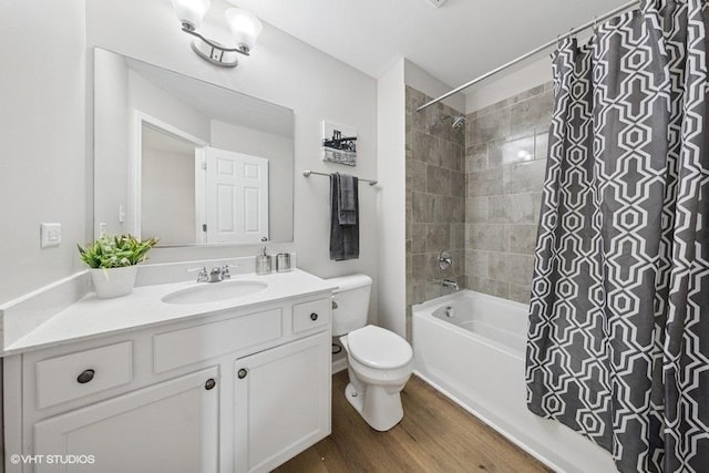 full bath featuring shower / bath combo with shower curtain, wood finished floors, toilet, and vanity