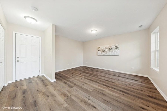 unfurnished room featuring wood finished floors and baseboards