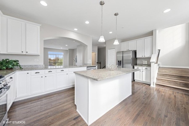 kitchen featuring recessed lighting, light stone countertops, dark wood-style flooring, stainless steel appliances, and white cabinets