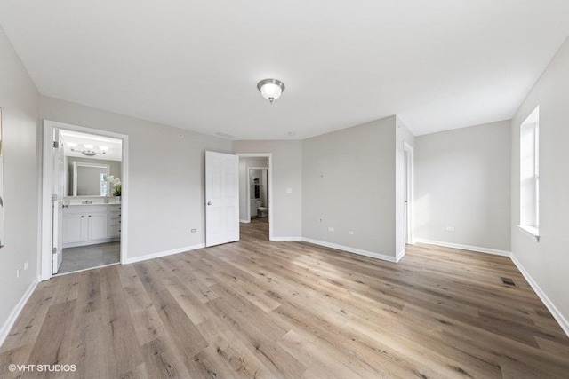 unfurnished bedroom featuring light wood-style flooring and baseboards