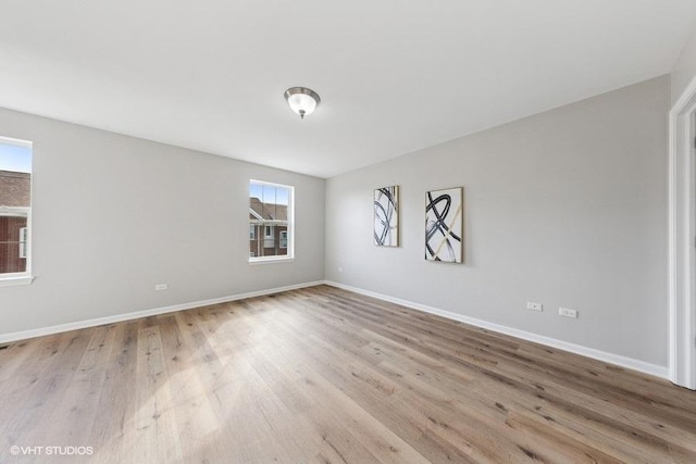 empty room featuring baseboards and wood finished floors