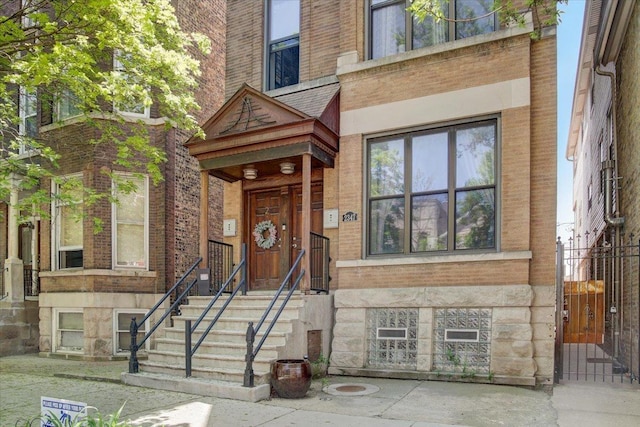 view of front of house featuring brick siding and stone siding