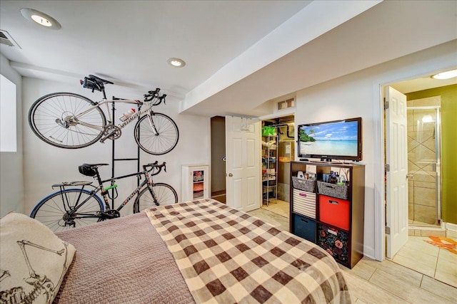 bedroom with light tile patterned floors, recessed lighting, visible vents, and connected bathroom