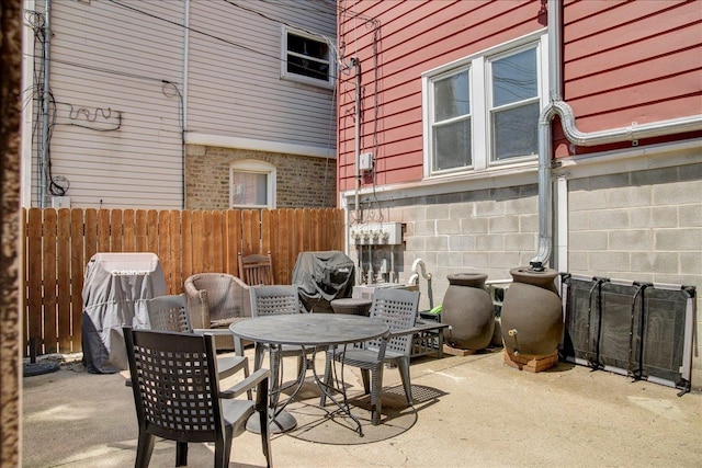 view of patio with fence and outdoor dining space
