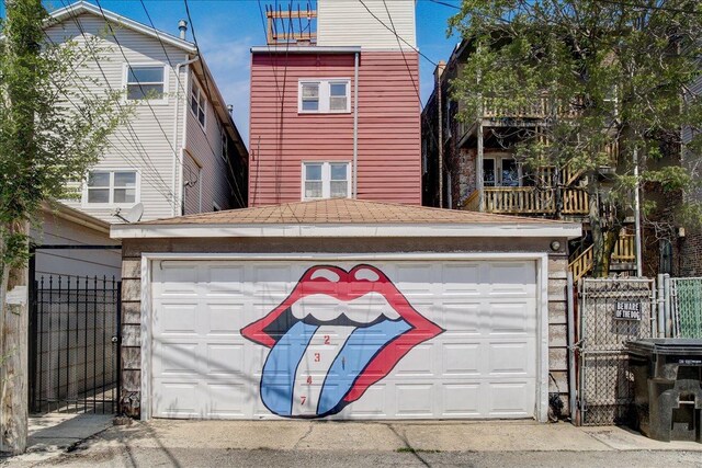 garage with a gate and fence