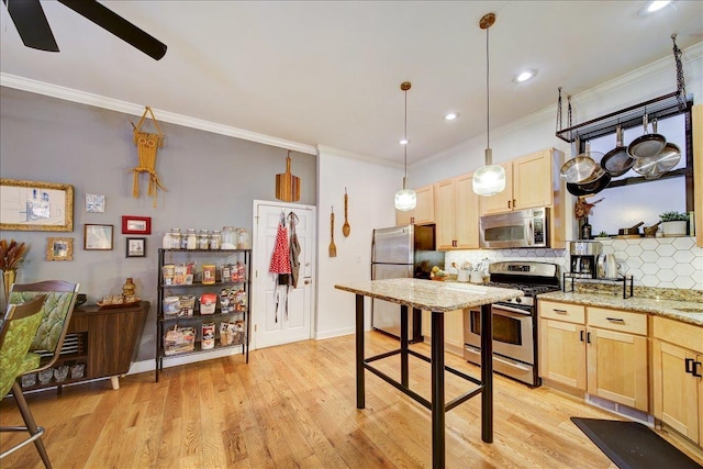 kitchen with appliances with stainless steel finishes, ceiling fan, light brown cabinets, and ornamental molding