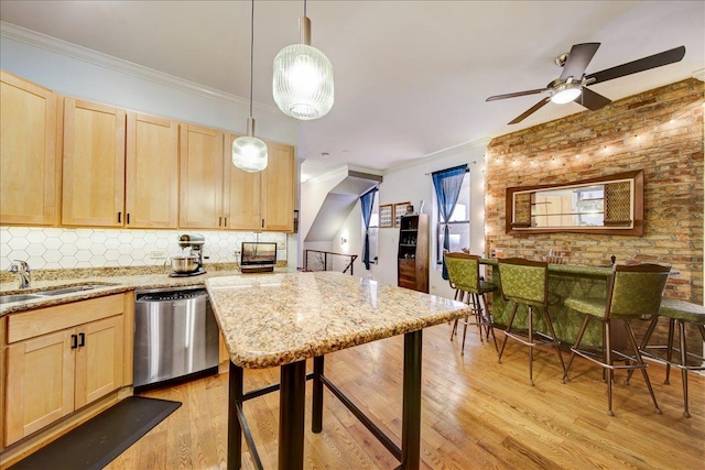 kitchen featuring a sink, light brown cabinetry, dishwasher, and light wood-type flooring