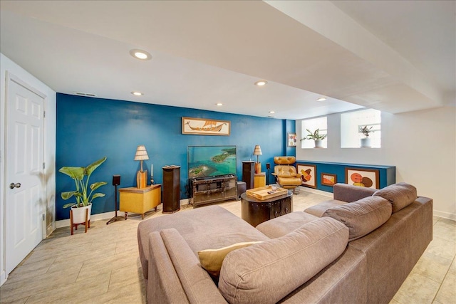 living room featuring light tile patterned floors, recessed lighting, an accent wall, and baseboards