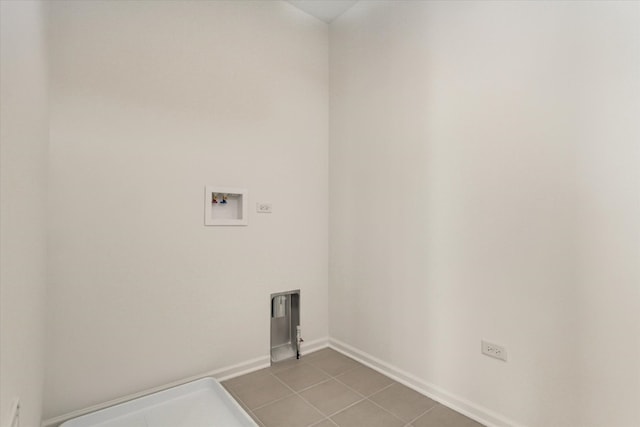 laundry area featuring baseboards, laundry area, and washer hookup