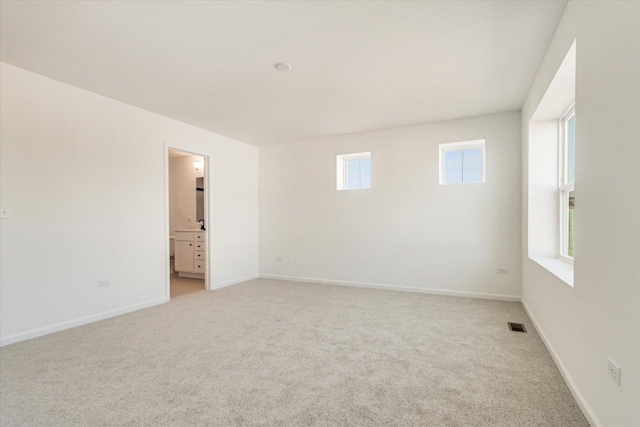 unfurnished room with light carpet, baseboards, and visible vents