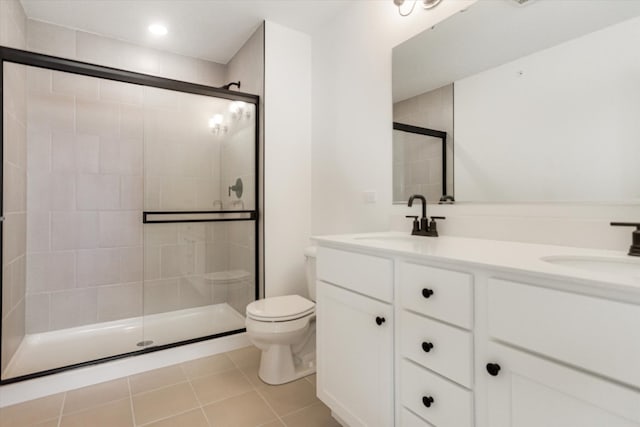 bathroom featuring toilet, a sink, and a stall shower