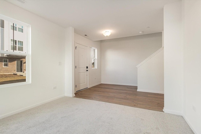 entryway with carpet and baseboards