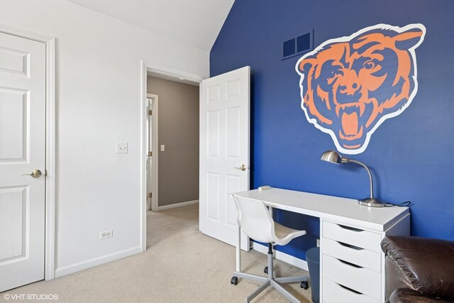 carpeted office space with lofted ceiling, visible vents, and baseboards