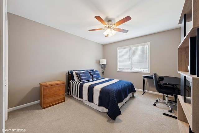 carpeted bedroom with a ceiling fan and baseboards