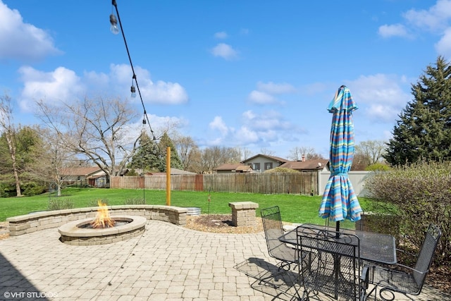 view of patio / terrace with a fire pit, outdoor dining area, and fence