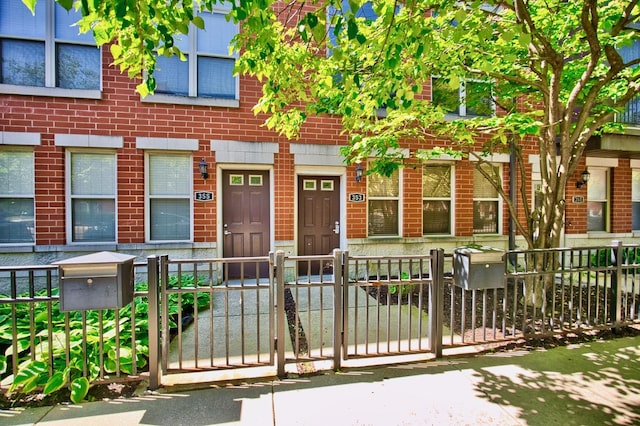 353 E Eastgate Pl, Chicago, IL 60616 - multi unit property featuring brick siding, a fenced front yard, and a gate