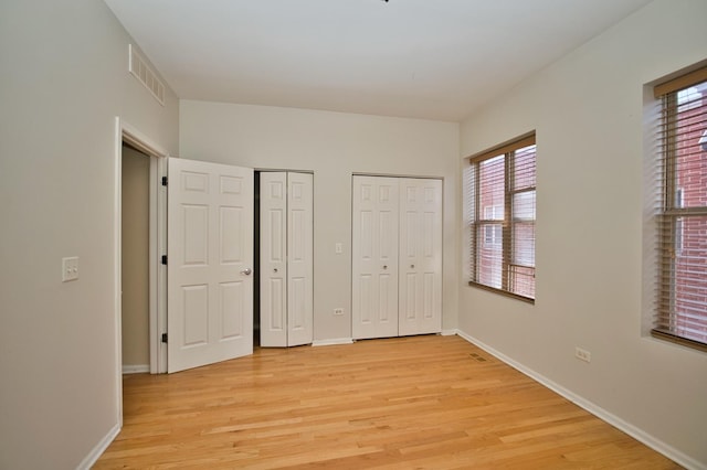 353 E Eastgate Pl, Chicago, IL 60616 - unfurnished bedroom with two closets and light wood finished floors