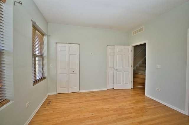 353 E Eastgate Pl, Chicago, IL 60616 - unfurnished bedroom with light wood finished floors and multiple closets