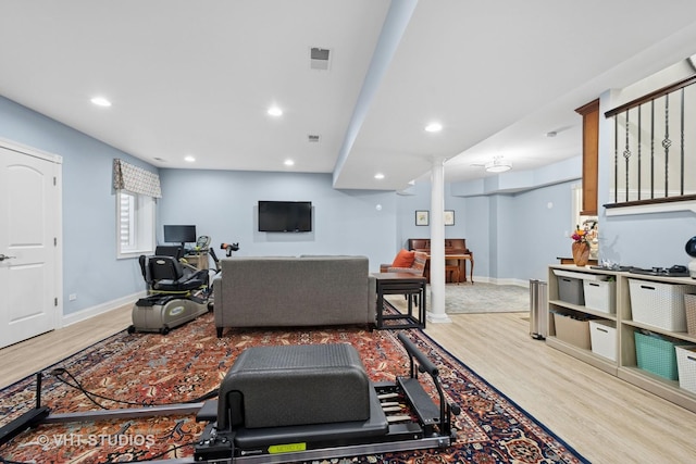 living area with visible vents, baseboards, recessed lighting, and wood finished floors