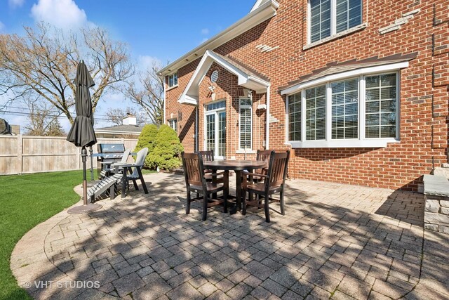 view of patio with outdoor dining area and fence