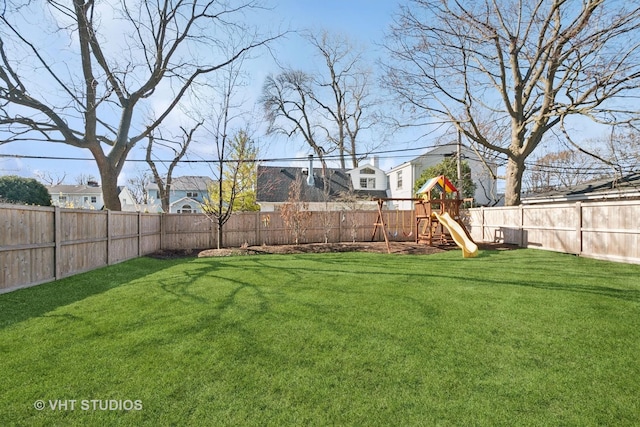 view of yard featuring a fenced backyard and a playground